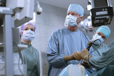 Team of neurosurgeons in scrubs during an operation