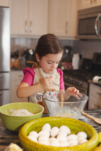Cute girl preparing food in kitchen