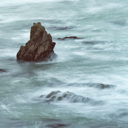 Long exposure water around rocks at pescadero beach.