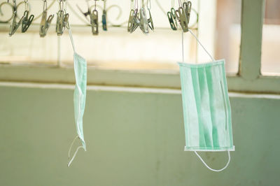 Close-up of clothespins hanging on rope