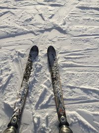 High angle view of ski equipment on snow covered land 