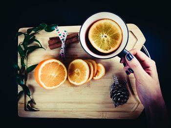 High angle view of orange slices and black tea