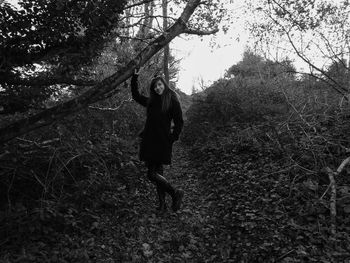 Portrait of young woman standing in forest