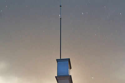 Lightning rod on a roof in a rainy night