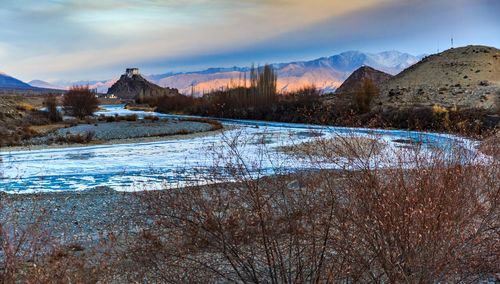 Scenic view of snowcapped mountains against sky during winter
