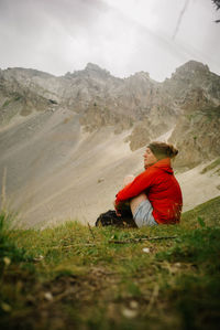 Rear view of woman sitting on field