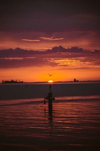 Scenic view of sea against orange sky