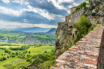 Scenic view of mountain against cloudy sky