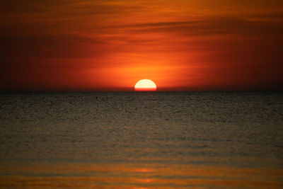 Scenic view of sea against romantic sky at sunset