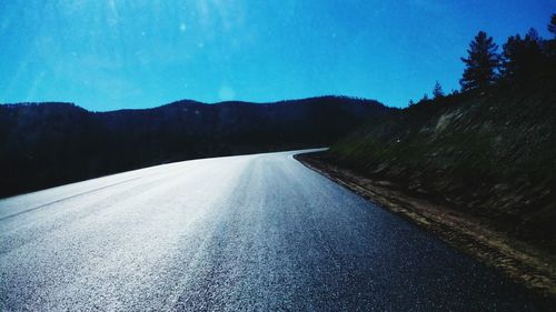 Surface level of road against blue sky