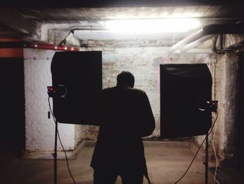 View of woman in dark room