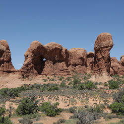 Rock formations in desert against clear sky