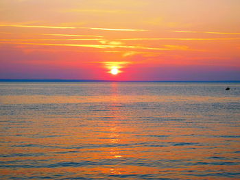 Scenic view of sea against orange sky