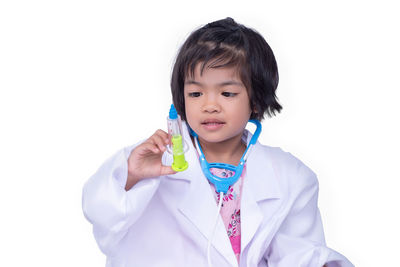 Portrait of cute girl standing against white background