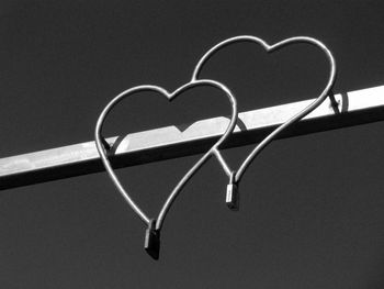 Close-up of heart shape on metal against gray background