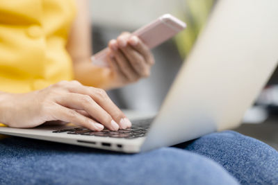 Midsection of man using mobile phone