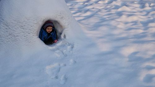 High angle view of child in snow