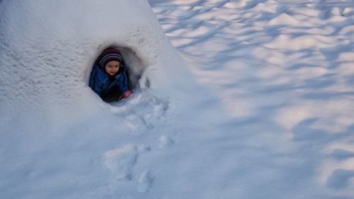 High angle view of girl playing in snow