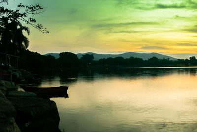 Scenic view of lake against sky during sunset