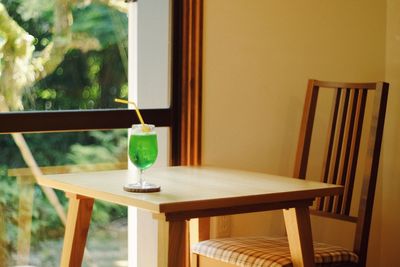 Empty chairs and table against window at home