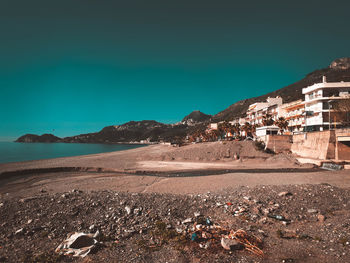 Scenic view of beach against clear blue sky