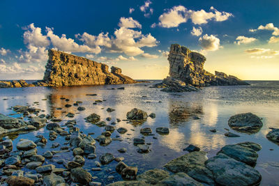 Sunrise over two rocks in the sea