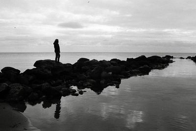 Man standing on beach against sky