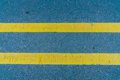 Full frame shot of yellow road marking on street