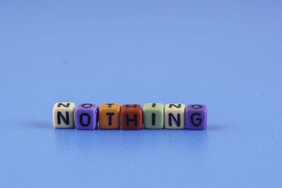 Close-up of text on table against blue background