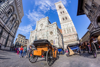 Low angle view of bicycles against cloudy sky