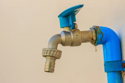 Close-up of faucet against clear blue sky