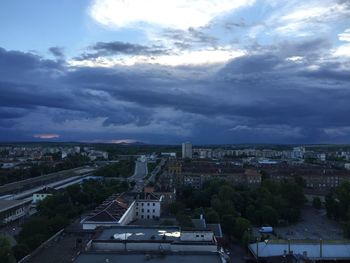 Cityscape against cloudy sky
