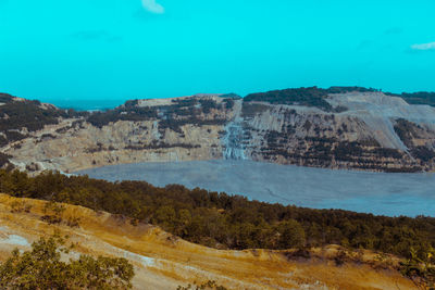 Scenic view of landscape against blue sky