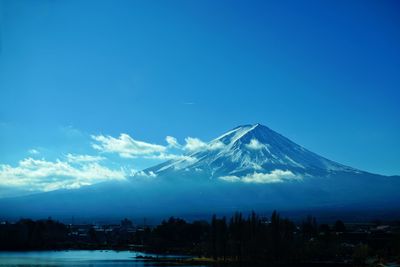 Scenic view of mountains against blue sky