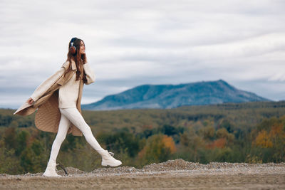 Rear view of woman standing on field