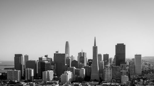 Modern buildings in city against clear sky