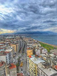 Aerial view of cityscape by sea against sky