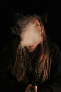 Young woman smoking at home