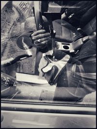 Close-up of man working on window