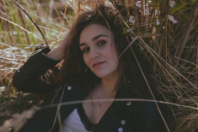 Close-up portrait of woman against plants