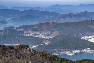 High angle view of townscape by mountains against sky