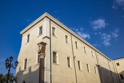 Low angle view of building against blue sky