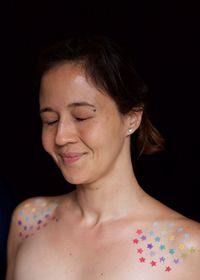 Close-up portrait of woman against black background