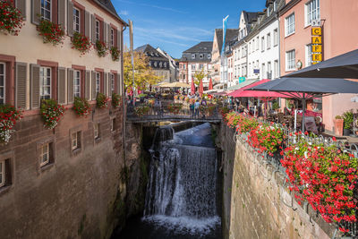 View of canal amidst buildings in city