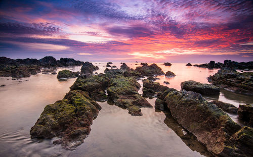 Scenic view of lake against sky at sunset