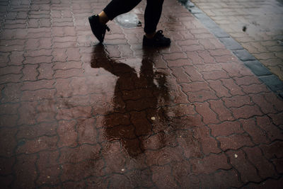 Low section of people walking on sidewalk