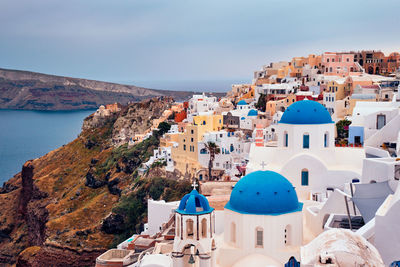 High angle view of townscape by sea against sky