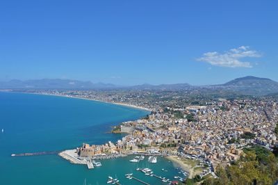 Aerial view of sea and buildings against sky