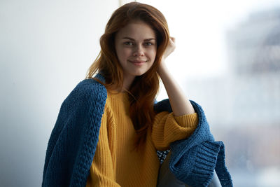 Portrait of smiling young woman standing in winter