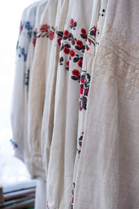 Close-up of clothes hanging on bed